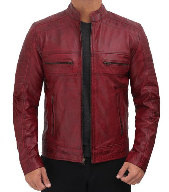 A man wearing a distressed red leather jacket with a stand collar, zippered chest pockets, and ribbed sleeve panels, shown against a plain white background.