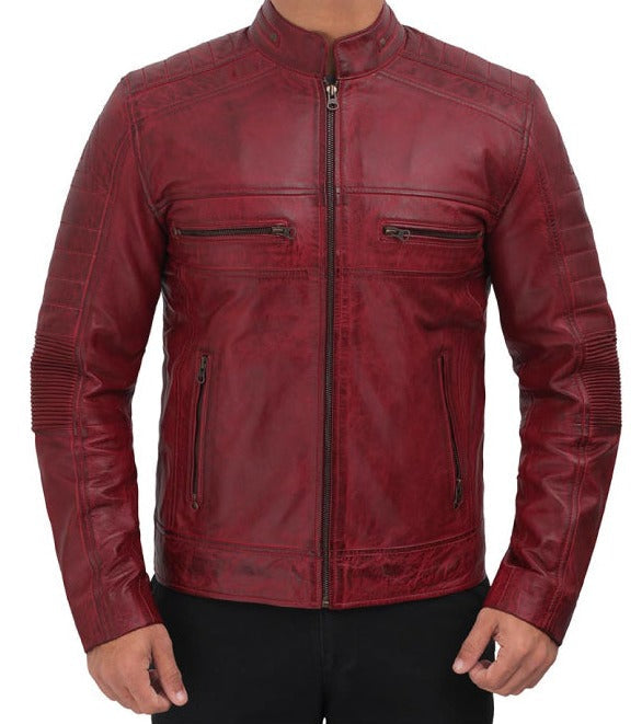 A men's distressed leather jacket in a deep burgundy red, featuring a full-length front zipper, two zippered chest pockets, and ribbed knit sleeve panels, shown on a model against a white background.