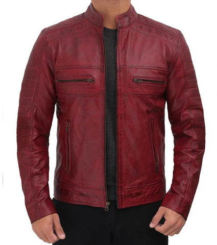 A man wearing a distressed red leather jacket with a stand collar, zippered chest pockets, and ribbed sleeve panels, shown against a plain white background.