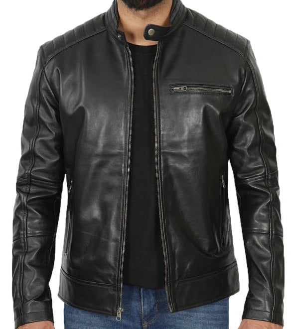 A black leather jacket with a stand collar, ribbed shoulders and cuffs, and a zippered chest pocket, shown on a model wearing a black shirt and blue jeans.
