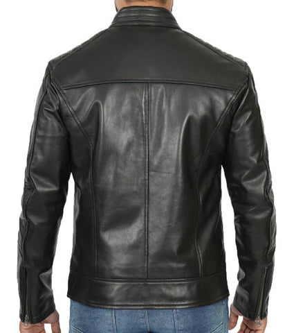 A man wearing a black leather jacket, viewed from the back. The jacket features a high collar, a central seam down the back, and zippered details on the sleeves, shown against a plain white background.