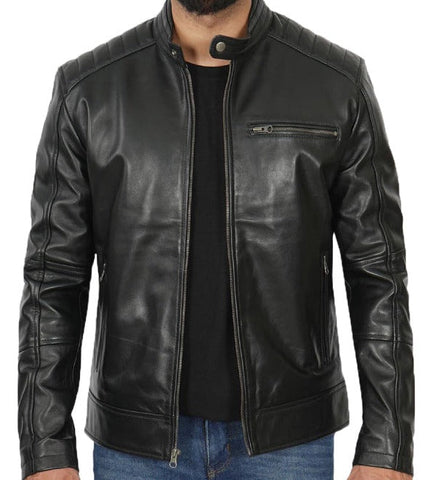 A black leather jacket with a stand collar, ribbed shoulders and cuffs, and a zippered chest pocket, shown on a model wearing a black shirt and blue jeans.