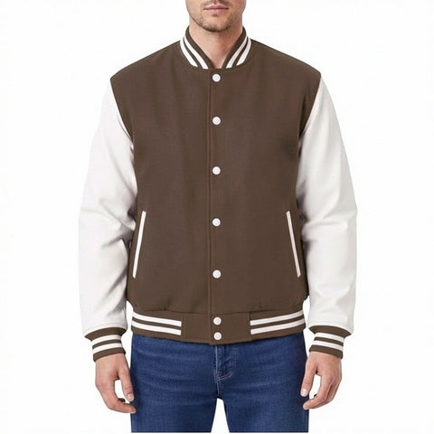 Fit to lead Traders unisex brown varsity jacket with white sleeves, ribbed collar, cuffs, and hem, and white snap buttons.