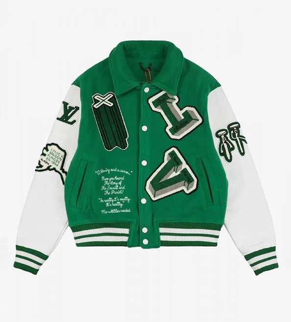 A green and white varsity-style jacket with embroidered letter patches, sleeve patches, and text details, shown flat on a light gray background.
