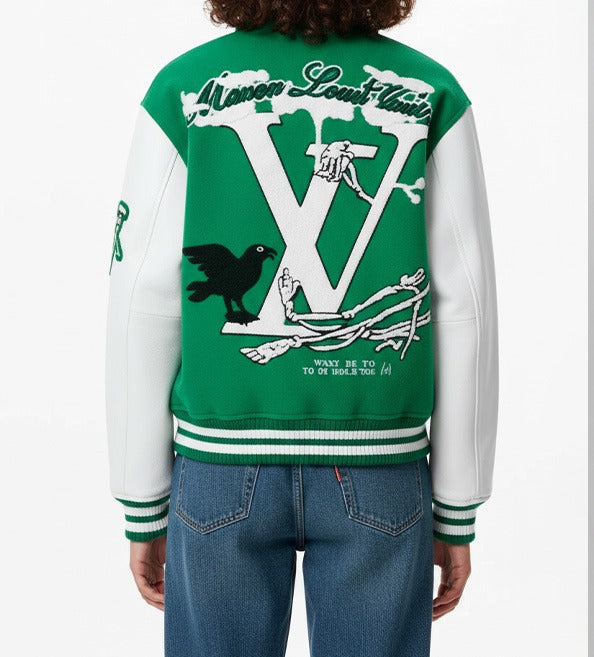 A person wearing a green and white varsity-style jacket, shown from the back. The jacket features a large white 'V' graphic with a skeleton keyhole and raven design, along with 'Mason Lowe Furniture' text and 'WANT IT TO GO HARD & TO YOU' on the back.