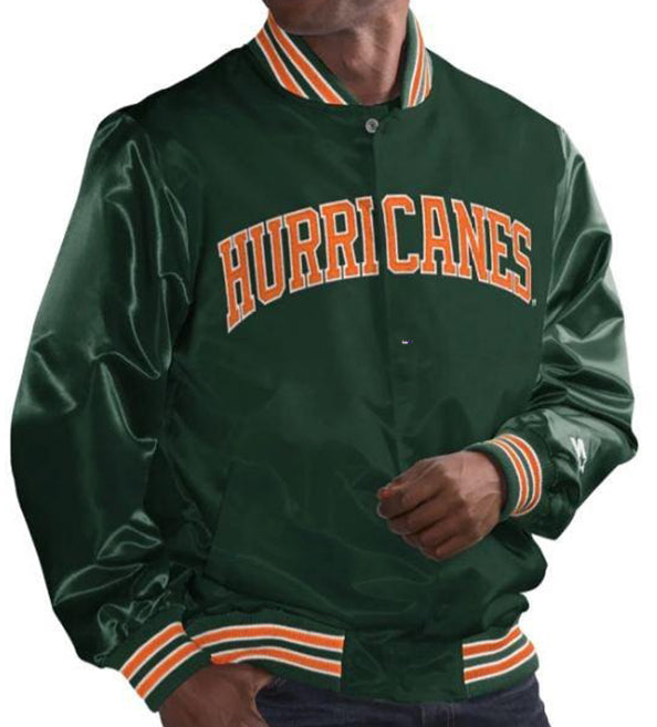 A dark green satin varsity jacket with 'HURRICANES' in orange block letters outlined in white across the chest, featuring orange and white striped ribbed trim on the collar, cuffs, and hem, worn by a model.