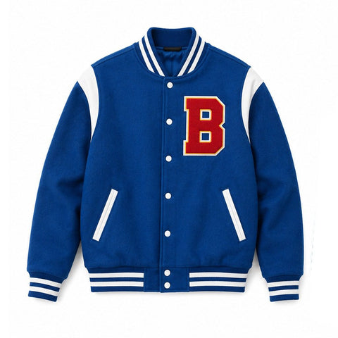 A royal blue varsity jacket with white ribbed trim, featuring a large red letter 'B' with a gold outline on the left chest. The jacket has white shoulder panels, white button closures, and white diagonal zippered pockets.