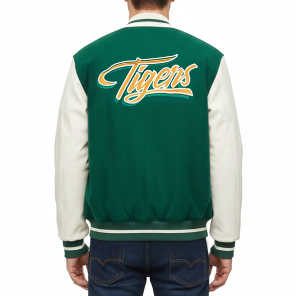 A person shown from the back wearing a varsity-style jacket with a dark green body, off-white sleeves, and a large yellow and white 'Tigers' script across the upper back.