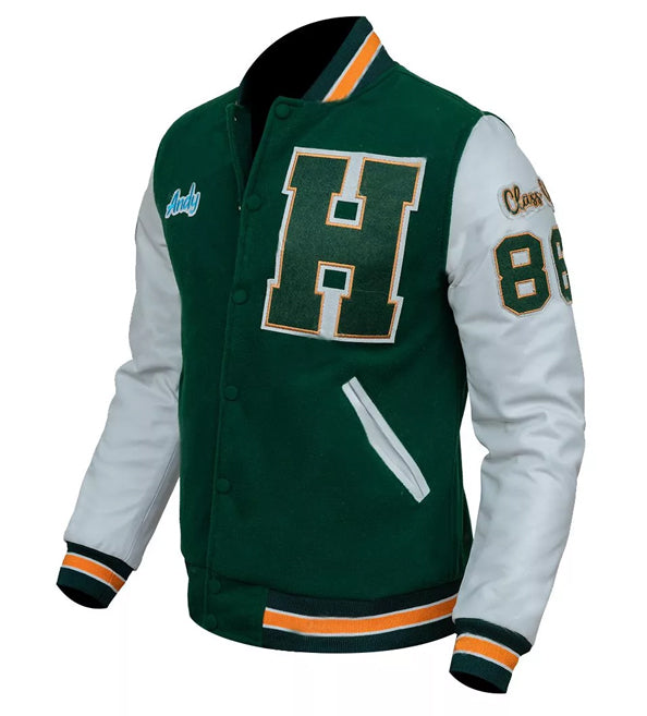 A green and white varsity jacket with a large green letter 'H' outlined in gold on the chest, white sleeves, and green, white, and orange striped ribbed cuffs and hem.