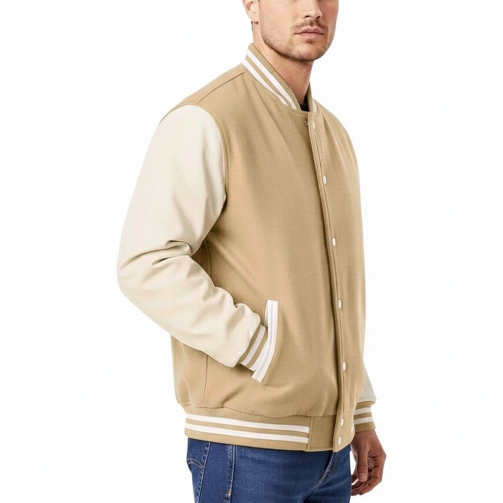 Tan varsity jacket with white accents worn by a person on a white background